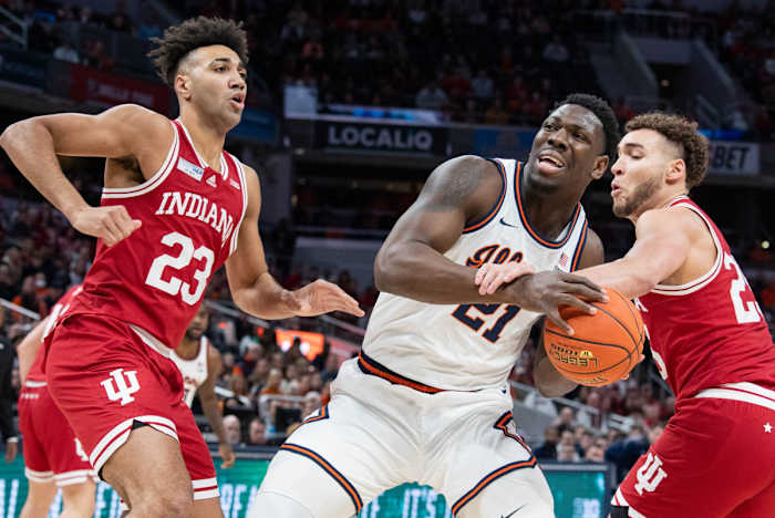 Trayce Jackson-Davis and Race Thompson guard Illinois' Kofi Cockburn.